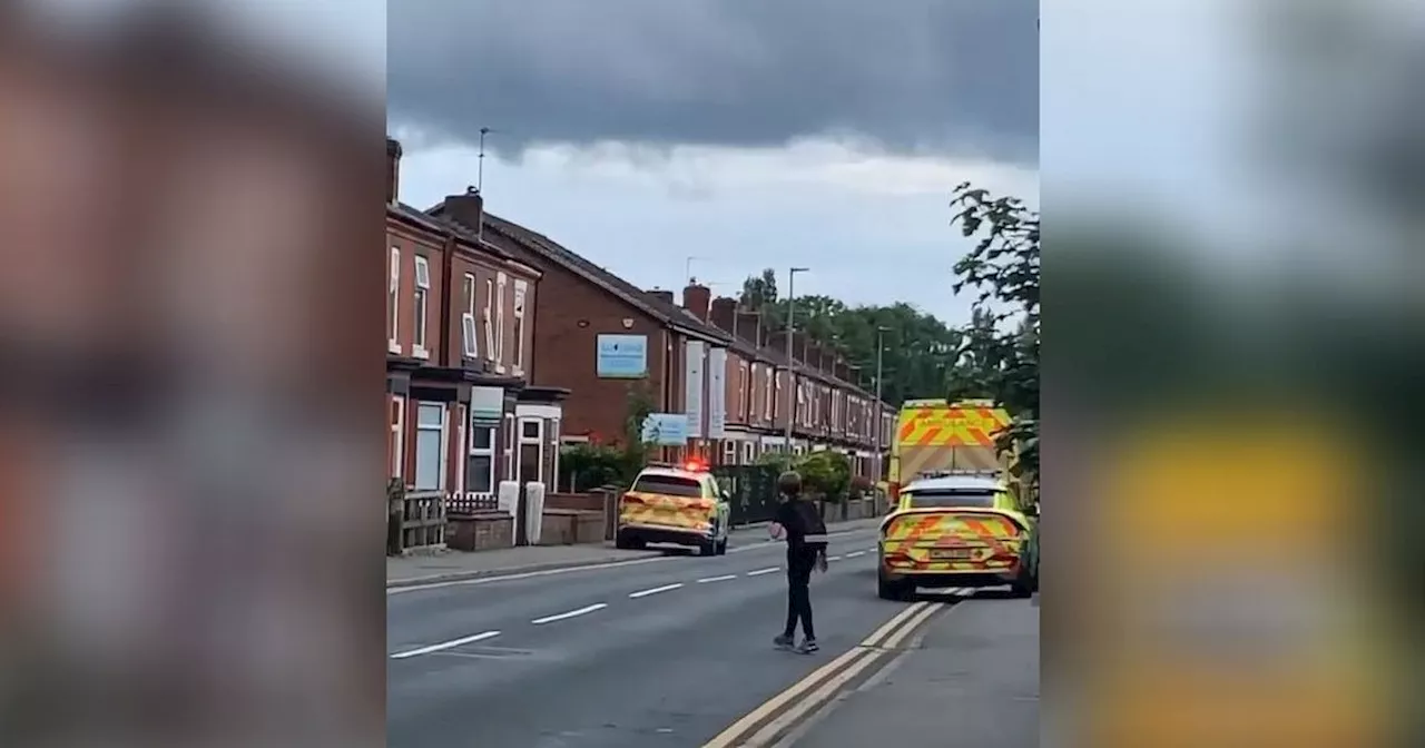 Suspect led away in handcuffs after police 'swarm' Salford street