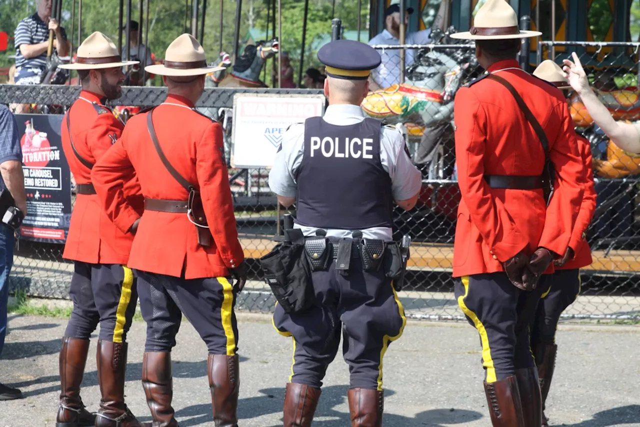 RCMP Musical Ride members inspect Chippewa carousel horses