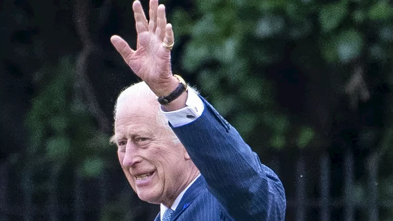 King Charles waves at wellwishers as he boards his helicopter to leave London after coming to...