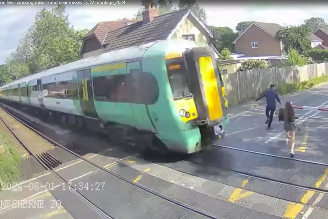 Terrifying CCTV footage shows girl almost get hit by train on level crossing