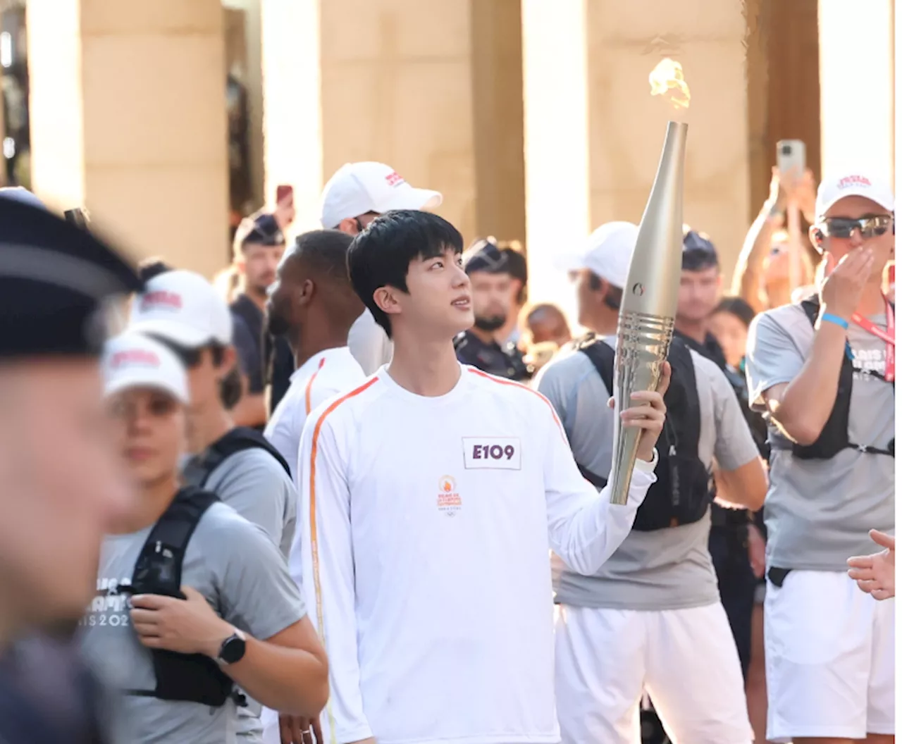 BTS' Jin carries Paris Olympics torch amid cheers from thousands of fans