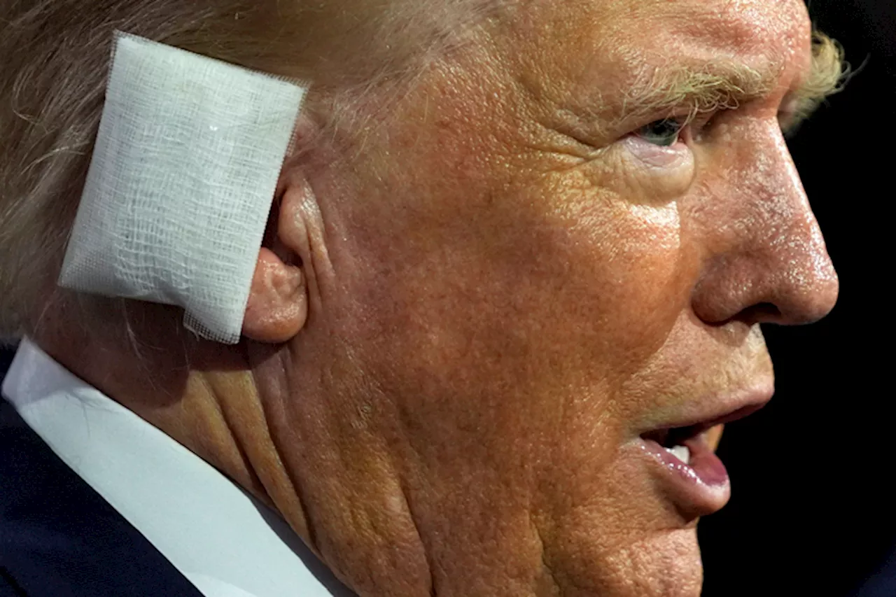 Donald Trump enters Republican convention hall with bandaged ear and receives a hero’s welcome