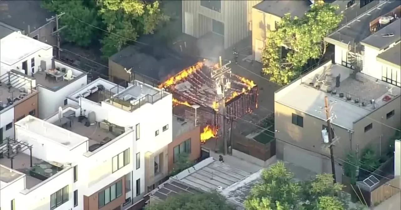 Denver garage fire near W 36th Ave. and Osage Street threatens power lines Tuesday morning