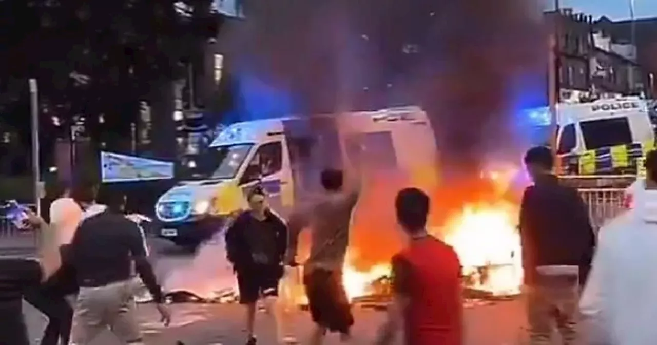 Bus set on fire and riot police 'under attack' by huge crowd as mass disorder erupts in Leeds