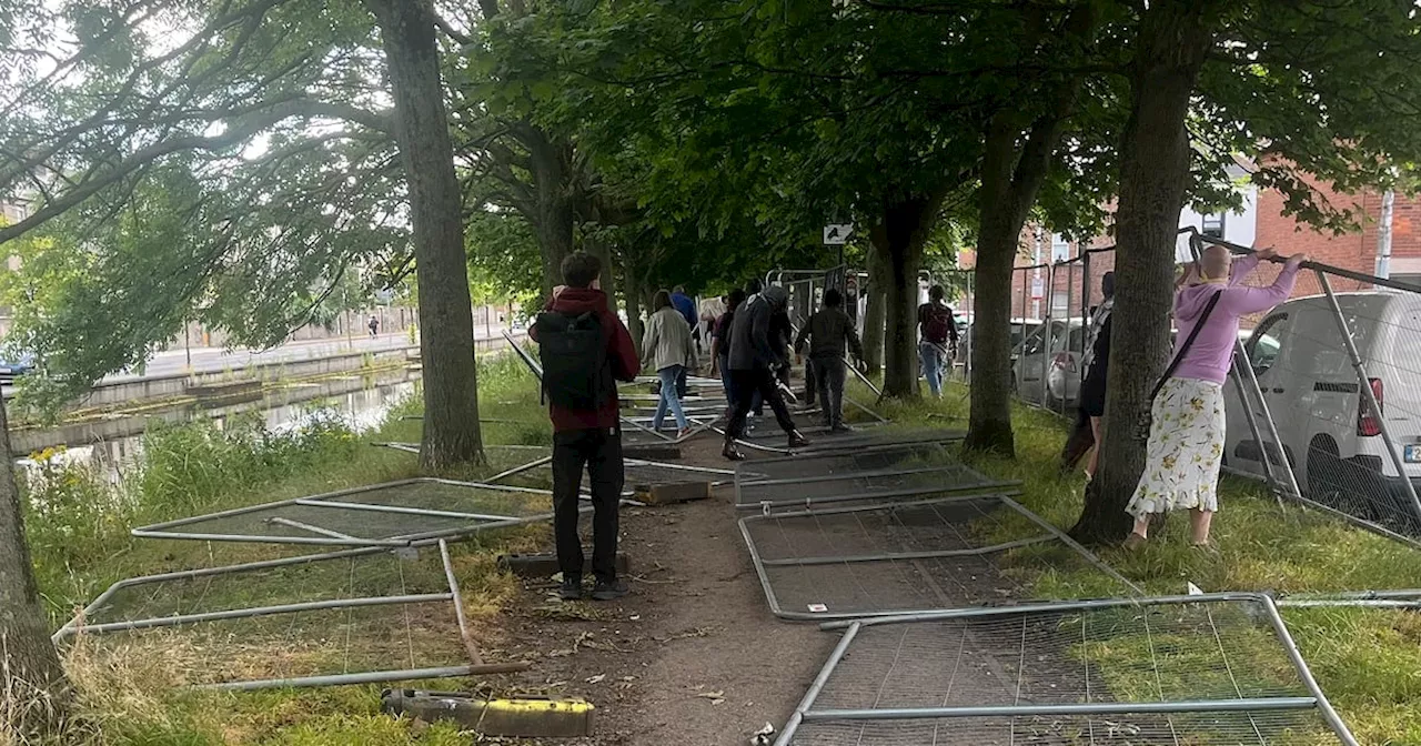 Protesters pull down fences erected to stop encampments along Dublin’s Grand Canal