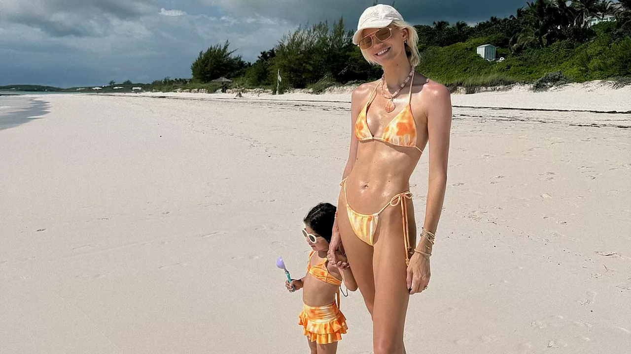 Devon Windsor showcases her fit form in a yellow and orange bikini as she enjoys the beach with...