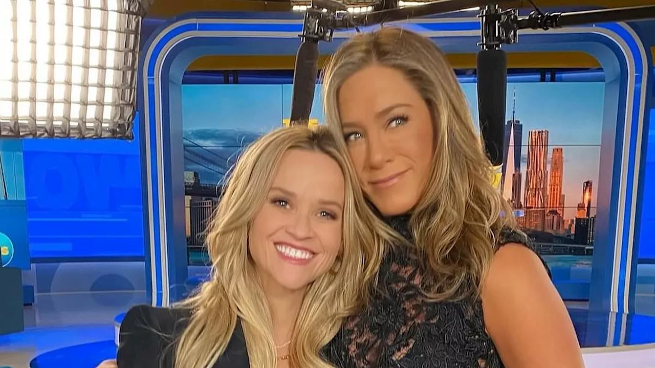 Jennifer Aniston cuddles up with Reese Witherspoon on The Morning Show set to celebrate their...