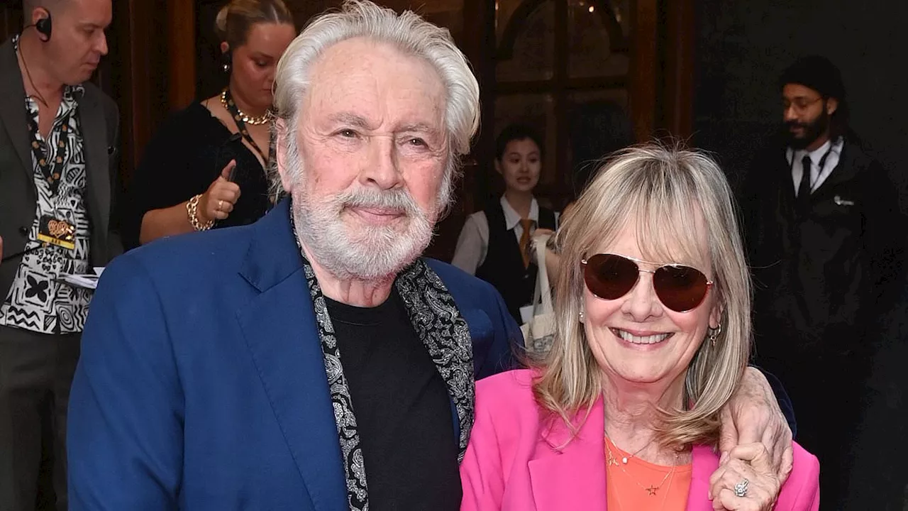 Twiggy, 74, looks sensational in a hot pink suit as she cosies up to her husband Leigh Lawson at...