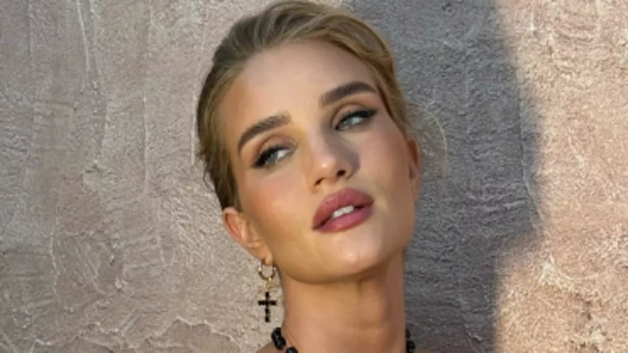 Rosie Huntington-Whiteley stuns in a semi-sheer lace jumpsuit as she poses for sizzling snaps in...