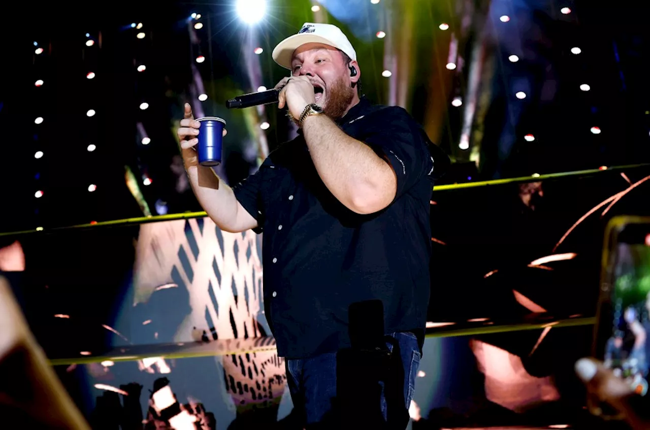 Watch Luke Combs Shotguns Beers With Glen Powell & ‘Twisters’ Co-Stars at NJ Concert