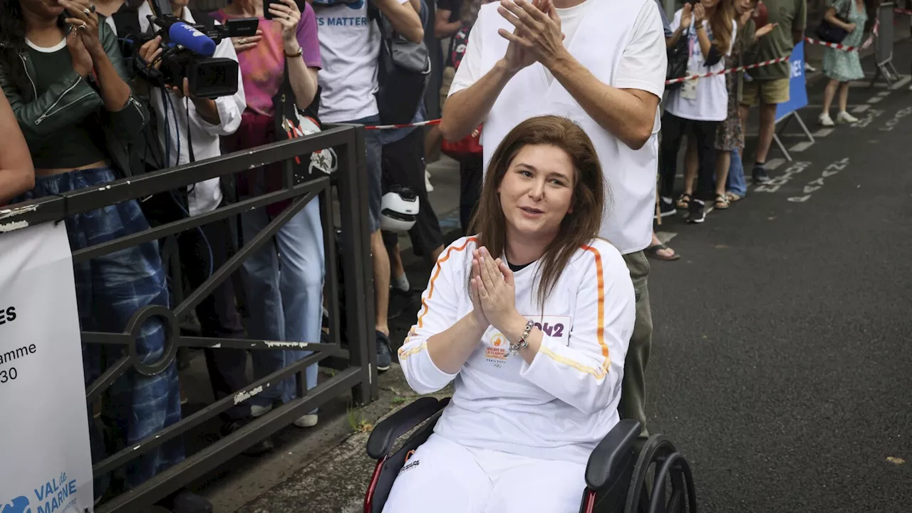 A Lebanese photojournalist, wounded in Israeli strike, carries Olympic torch to honor journalists