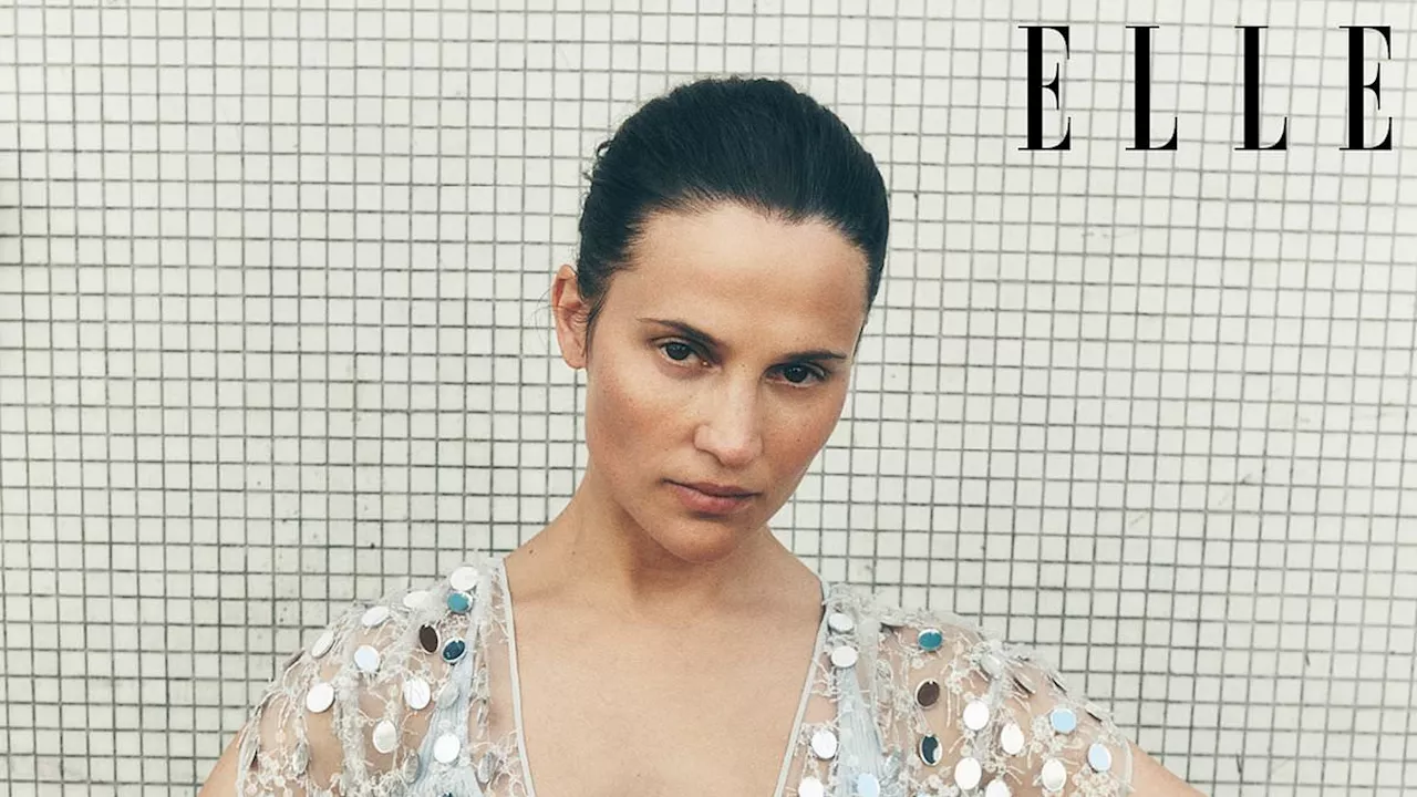 Alicia Vikander wows in a grey bra and see-through top in a striking shoot for ELLE UK as she opens...