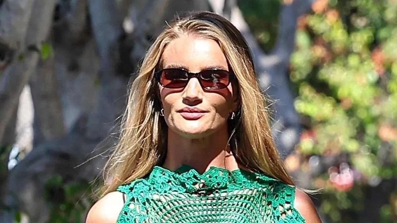 Rosie Huntington-Whiteley looks incredible in a see-through green crochet top as she heads out...