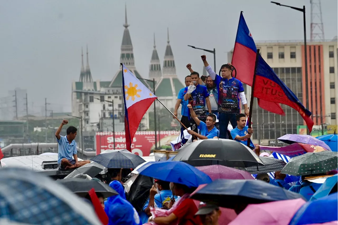 Undeterred by downpour, groups march to reject Marcos’ Bagong Pilipinas