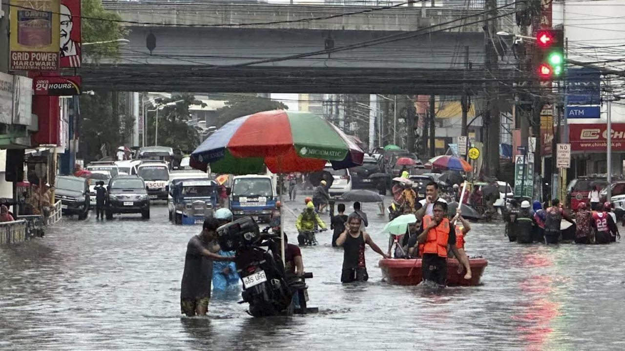 Monsoon rains worsened by offshore typhoon leave 8 dead and displace 600,000 in Philippines