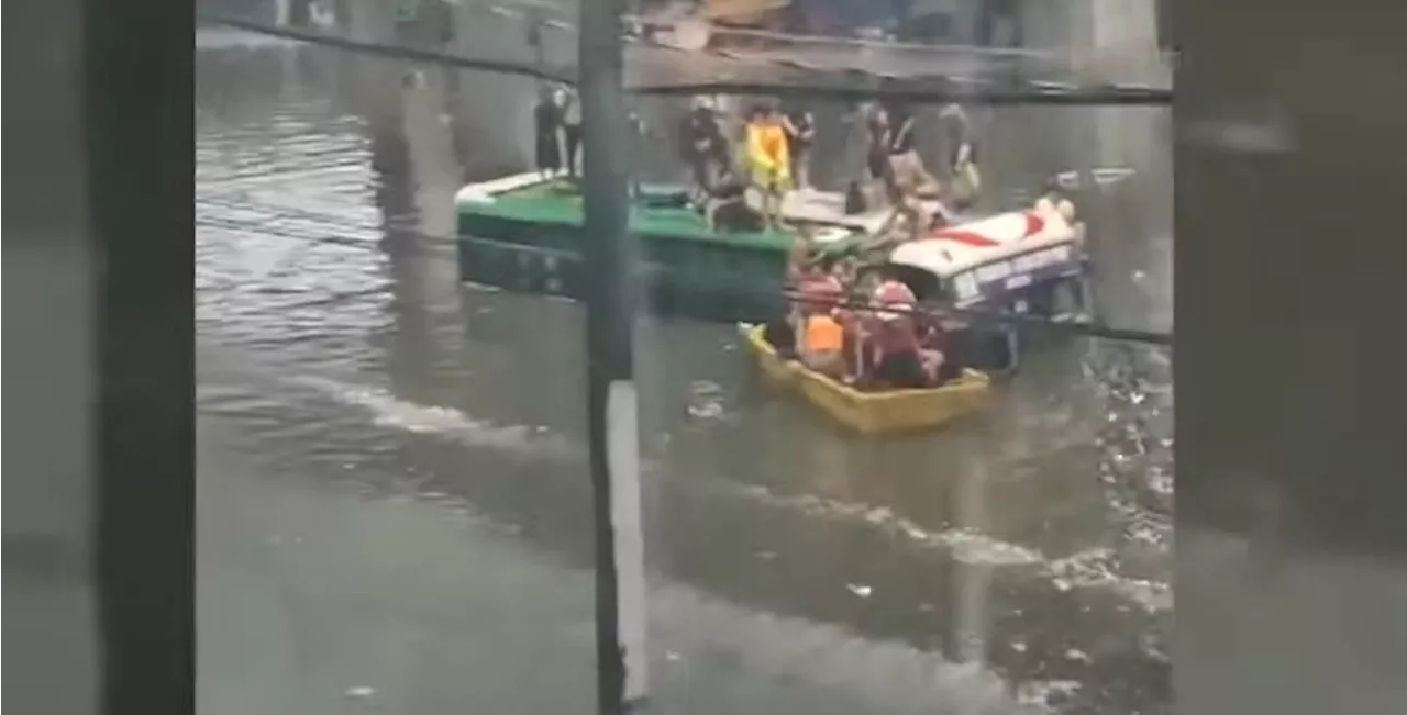 Passengers climb bus' roof on flooded Araneta Avenue