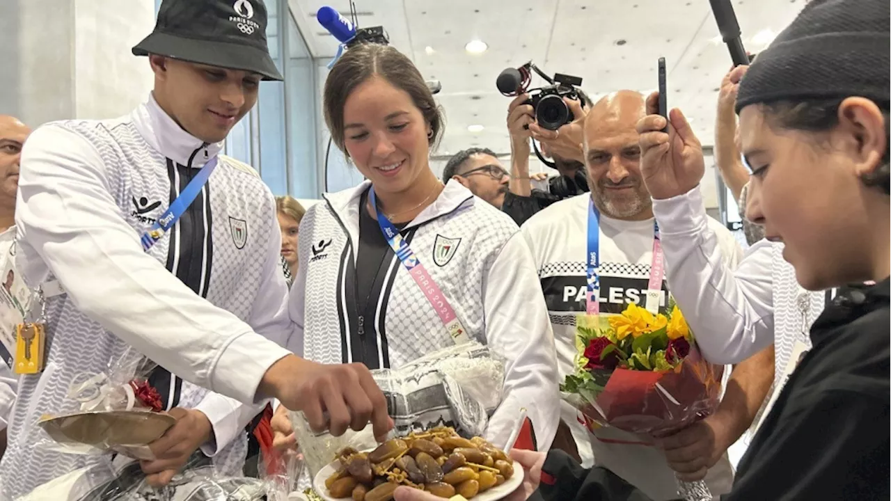 Palestinian Olympic team greeted with cheers and gifts in Paris