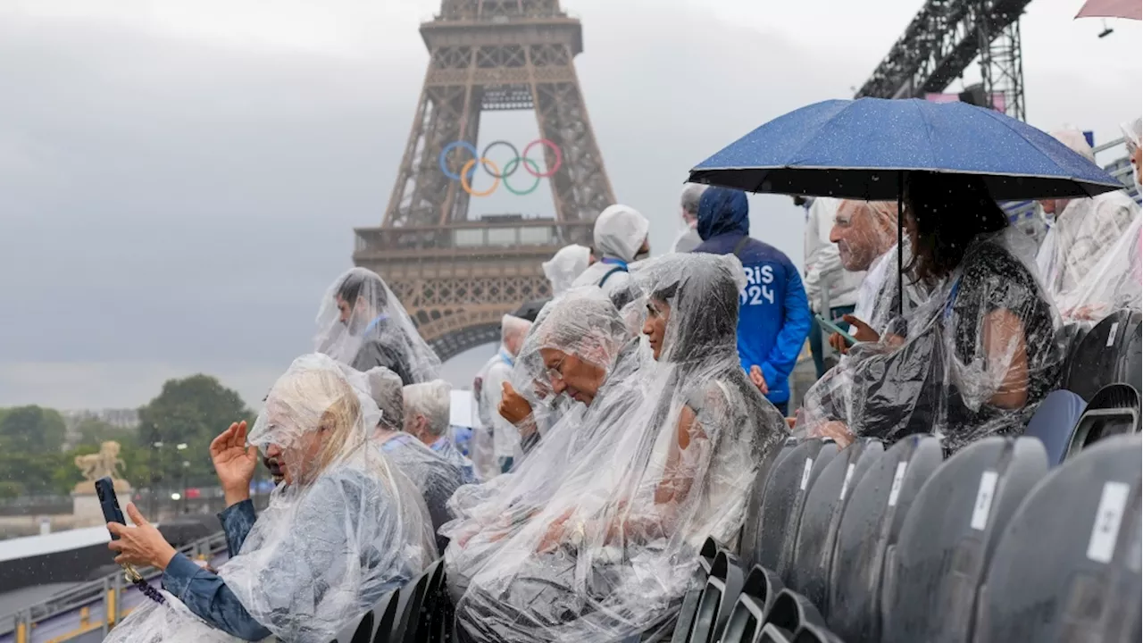 Thousands of fans take place along River Seine for rainy Olympic opening ceremony