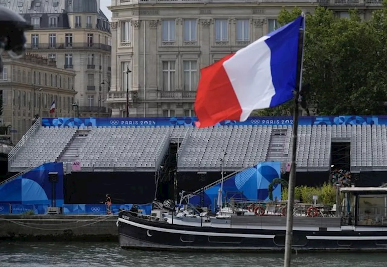 Thousands of fans take place along River Seine for rainy Olympic opening ceremony