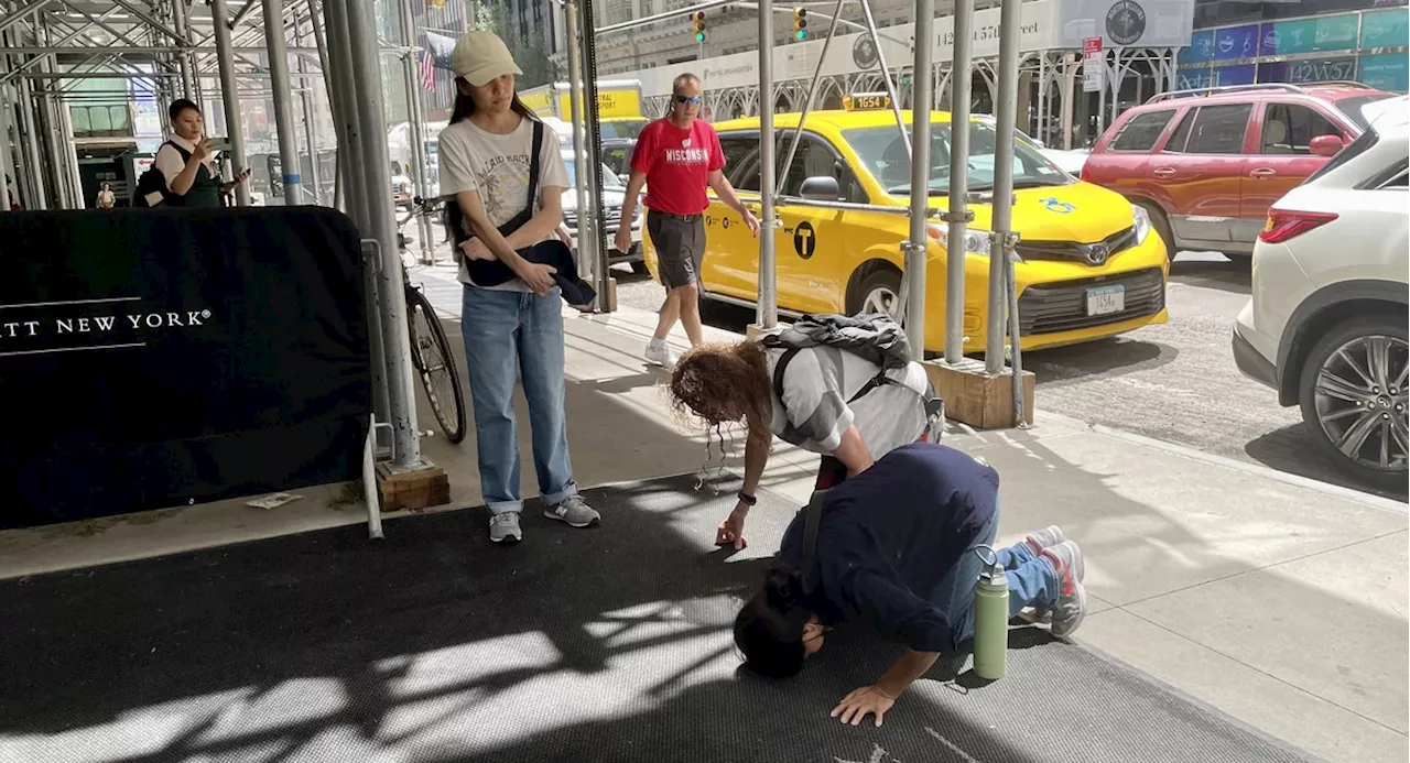 Outside a Midtown hotel, devotees pray for the Dalai Lama's recovery