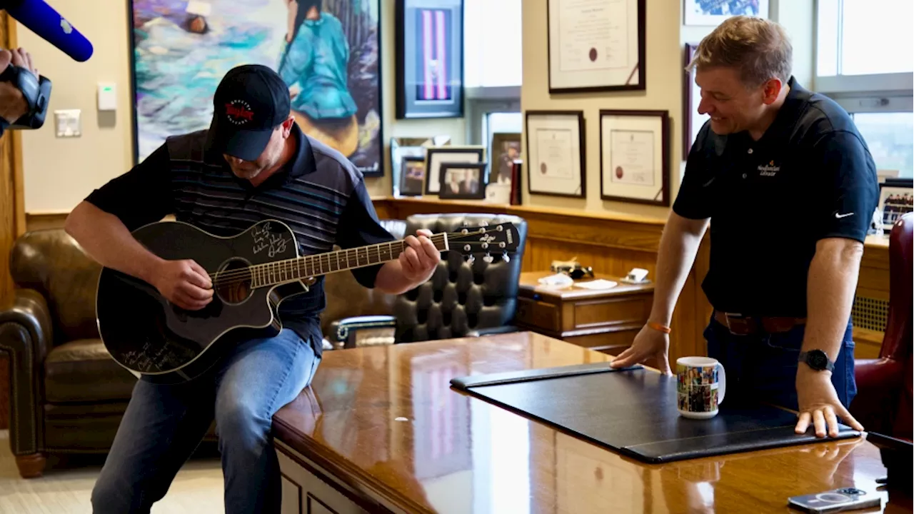 N.L. Premier gifts new guitar christened by music icon to one of the 'Lucky Seven'