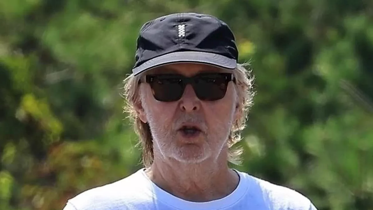 Paul McCartney, 82, cuts a relaxed figure as he enjoys a beach day with his leggy wife Nancy, 64, in...