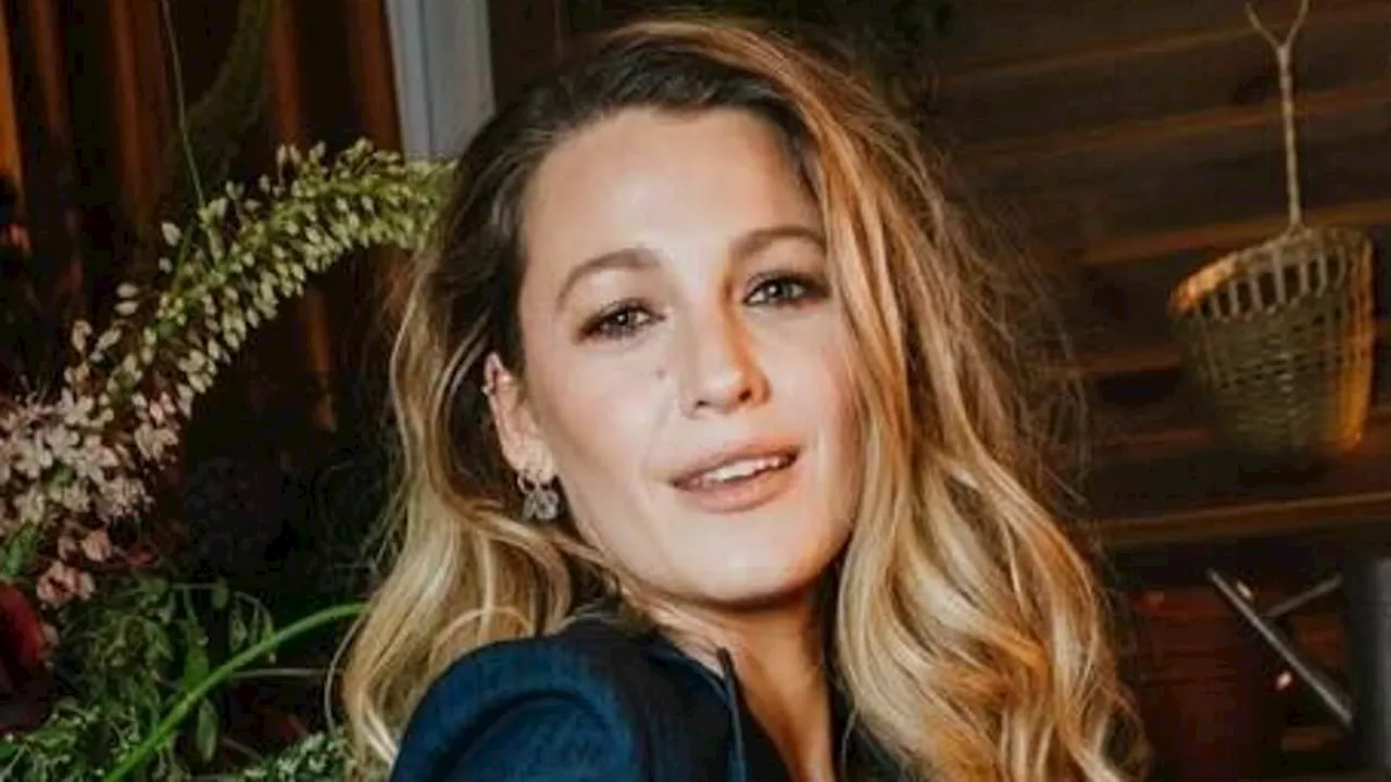 Blake Lively wows in ab-baring double denim look with crystal floral decals as she promotes new film...