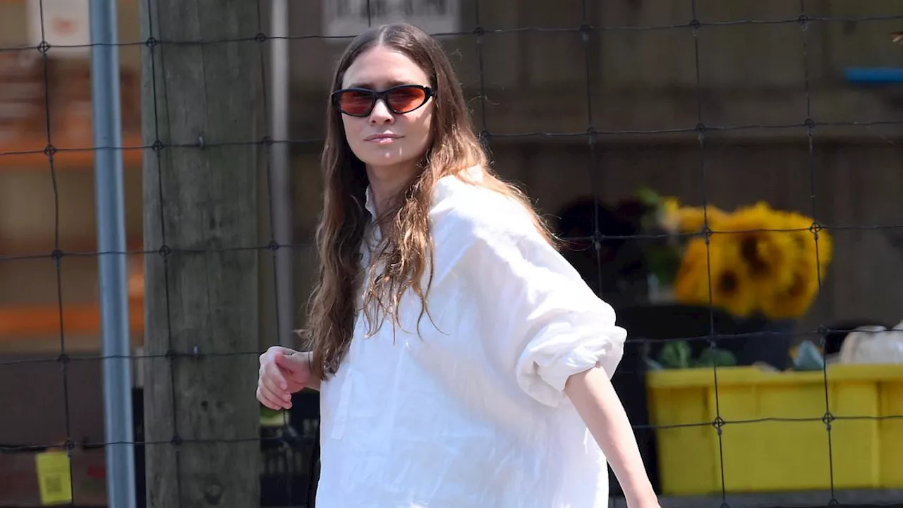 Ashley Olsen is effortlessly chic in billowing top as she heads to the market with husband Louis...