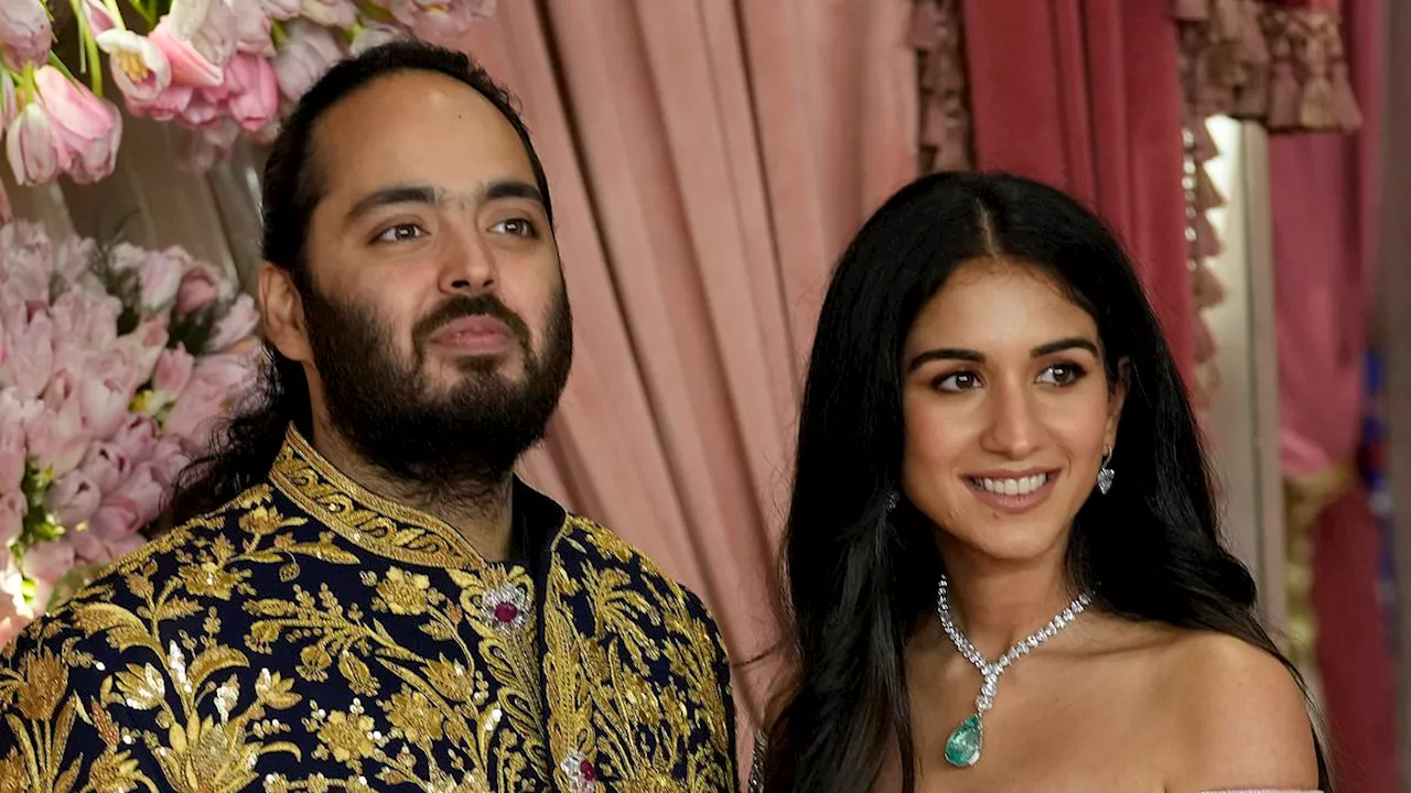 Billionaire heir Anant Ambani and fiancée Radhika Merchant flaunt their wealth in gold outfits at...