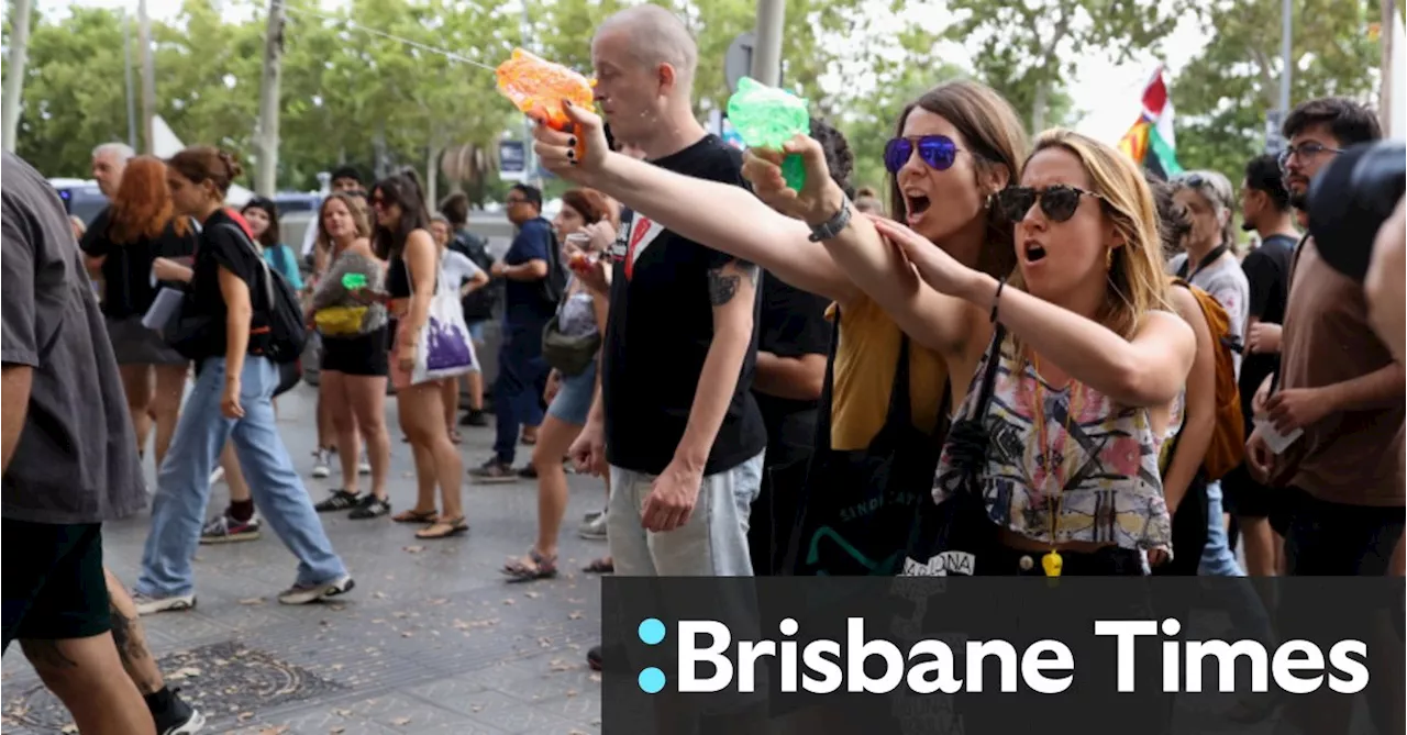 ‘Tourism kills the city’: Protesters soak diners with water pistols