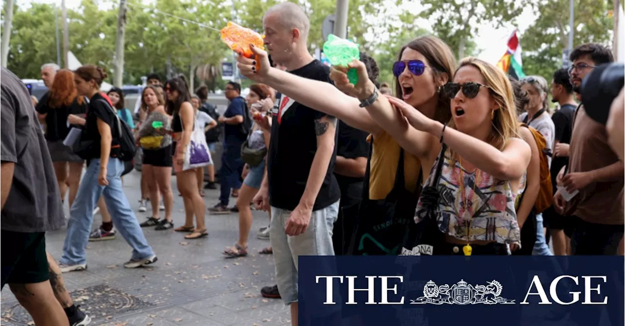 ‘Tourism kills the city’: Protesters soak diners with water pistols
