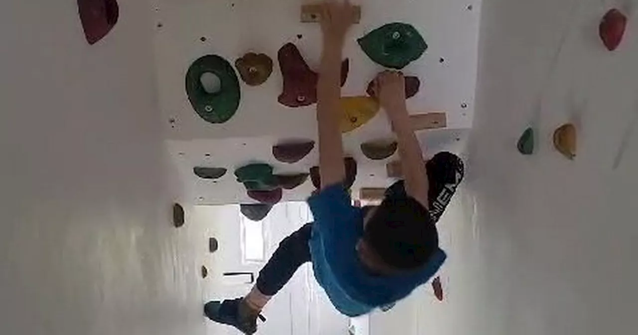 Dad transforms stairs into £700 climbing wall so son with Tourettes can practice