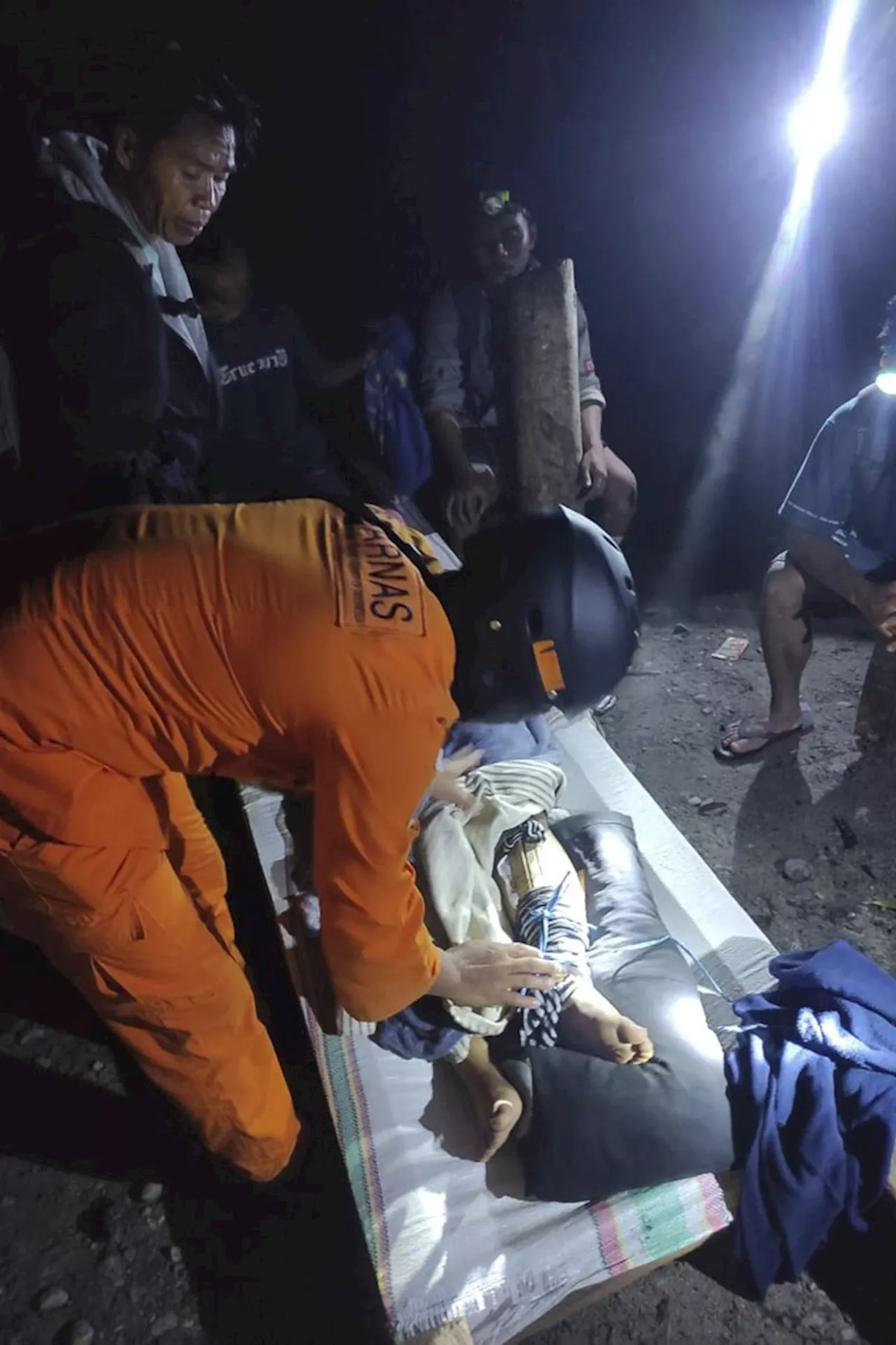 Rescuers search for dozens buried in an Indonesian landslide that killed at least 17 people