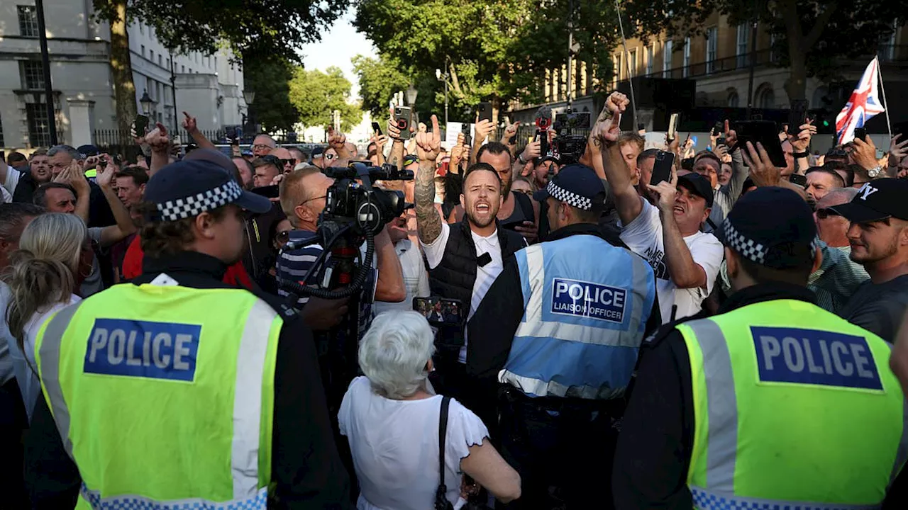 Protesters wearing tops with Southport victims faces descend on London