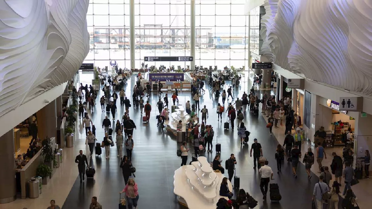 Man police say tried to open airplane door charged after emergency landing in Salt Lake City