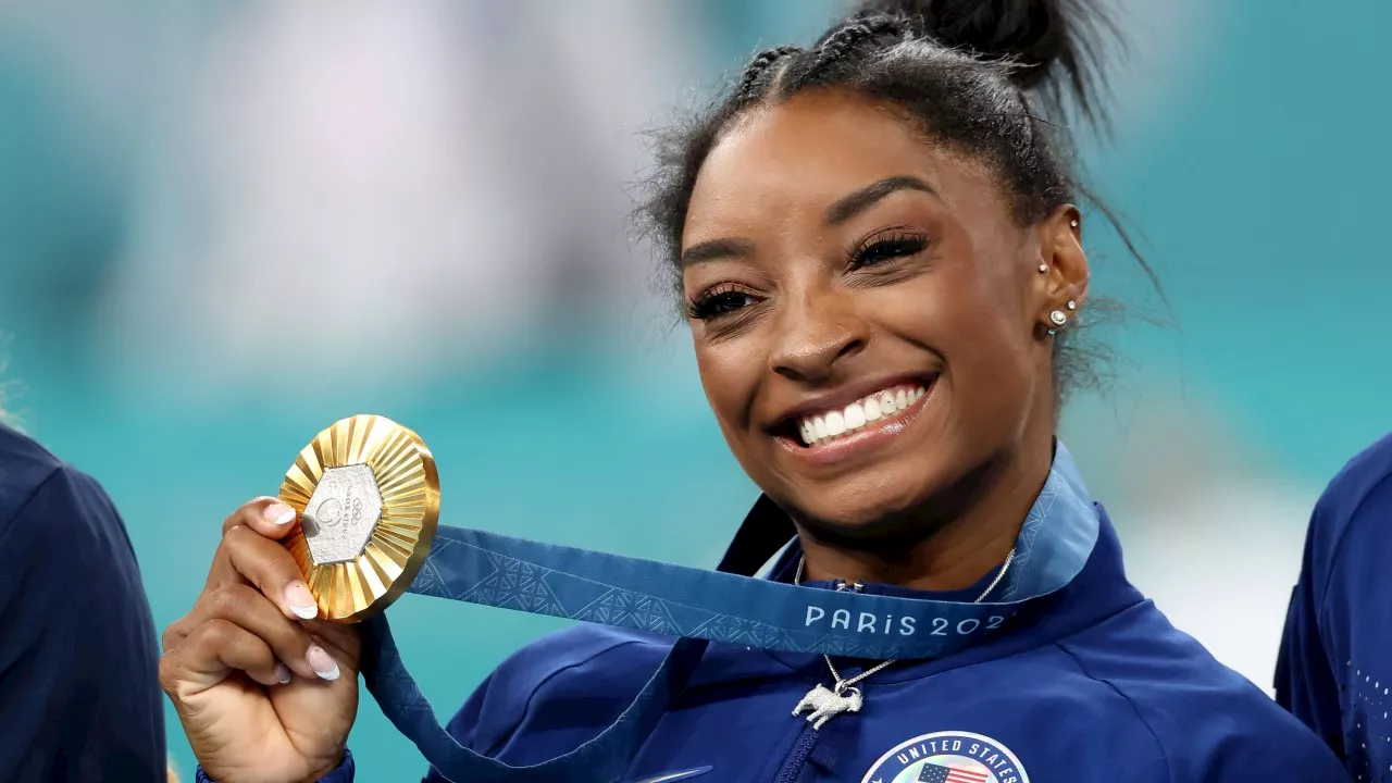 Simone Biles flashes goat necklace as she wins all-around title