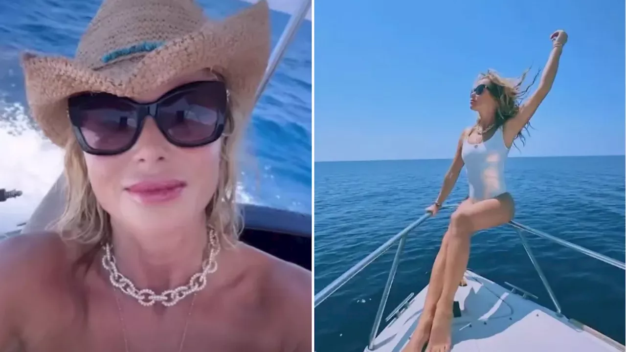 ‘Topless’ Amanda Holden poses on speedboat on romantic Greek trip with her husband...