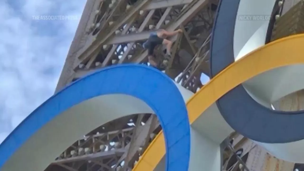 Police arrest a man climbing the Eiffel Tower, prompting an evacuation hours before closing ceremony