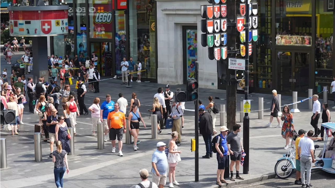 Police in London say a man is arrested after a child and adult were stabbed in a busy square