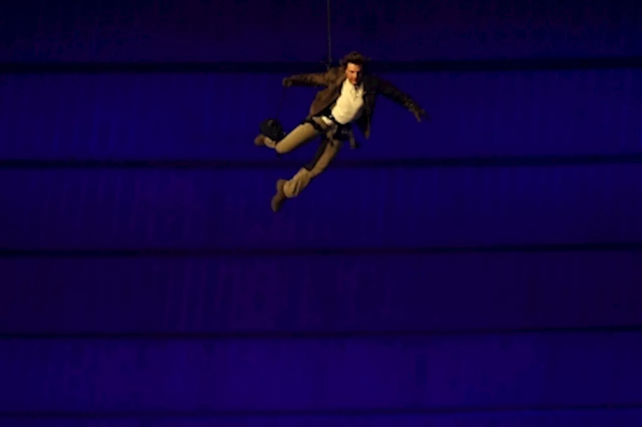 Seine-sational! Hollywood ending to Paris Olympics as Tom Cruise abseils off Stade de France roof (VIDEO)