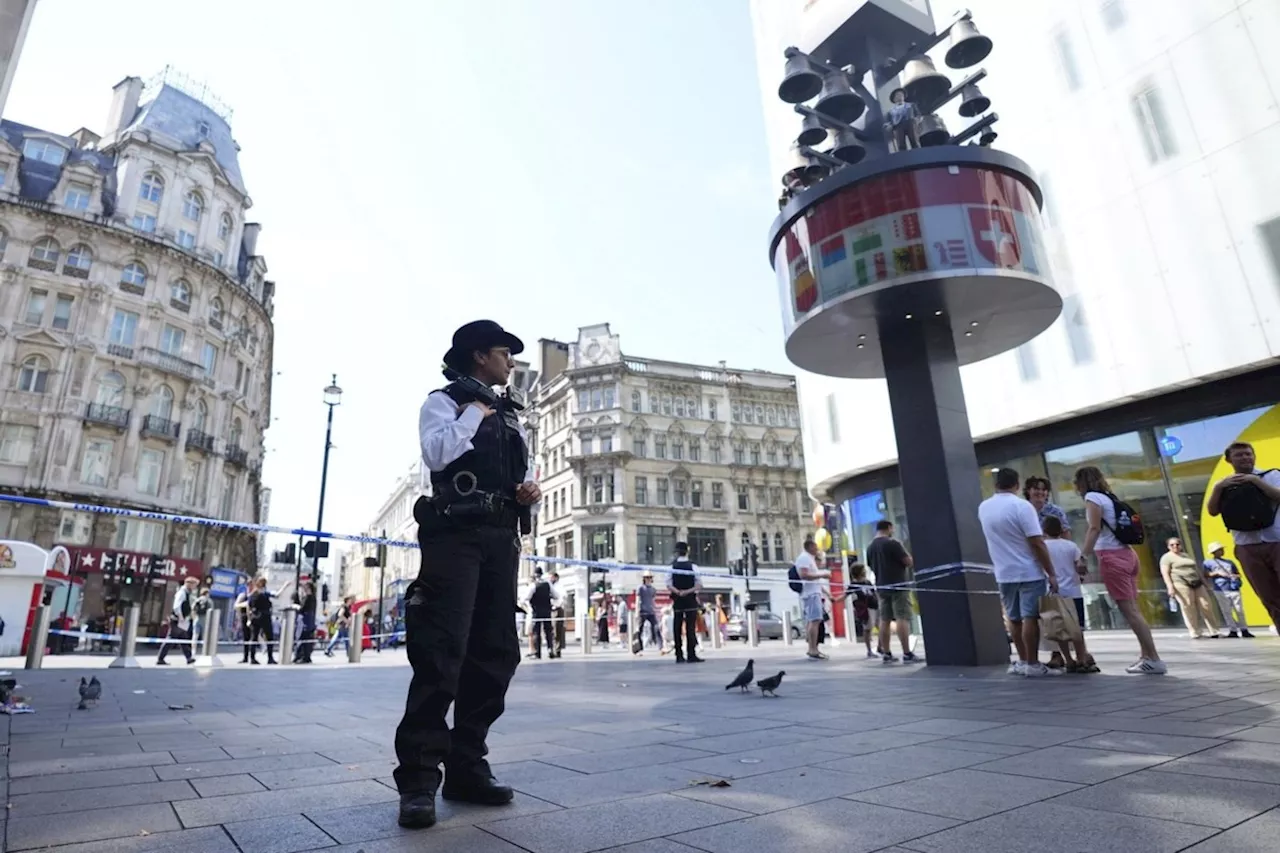 Police in London say a man is arrested after a child and adult were stabbed in a busy square