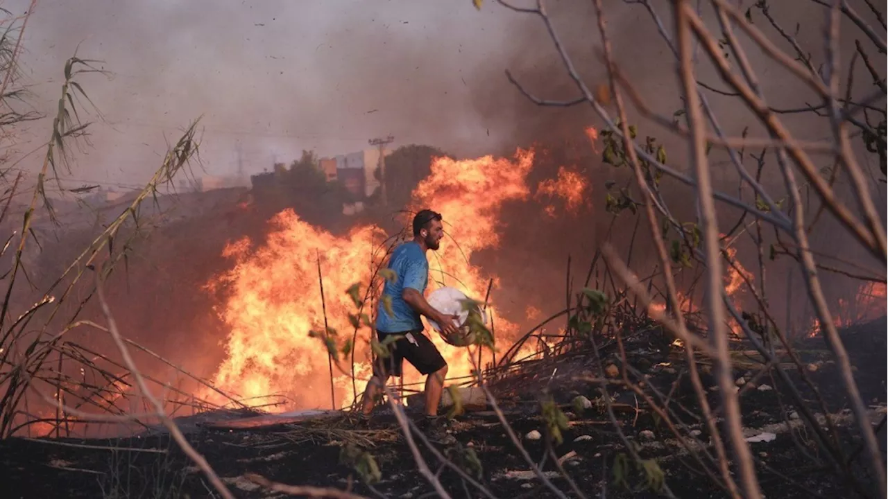 Crews battle scattered fires in Athens suburbs, helped by calmer winds and reinforcements