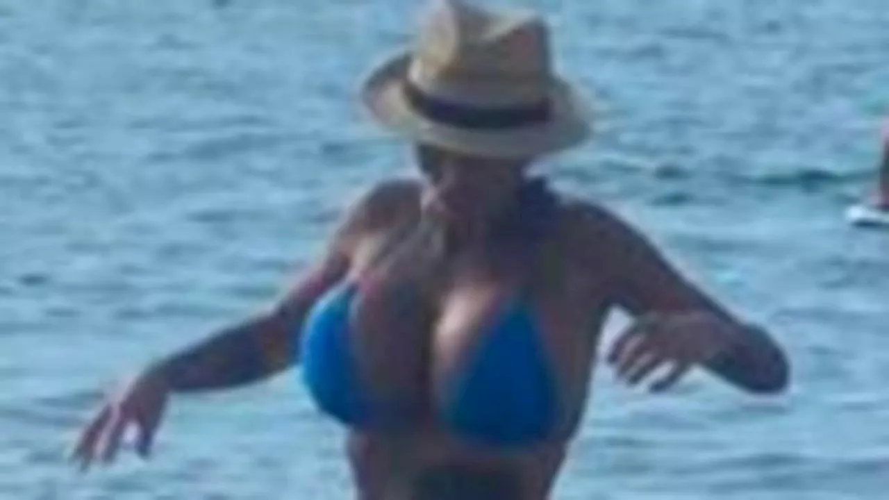 Katie Price shares busty bikini snap before frolicking in the sea