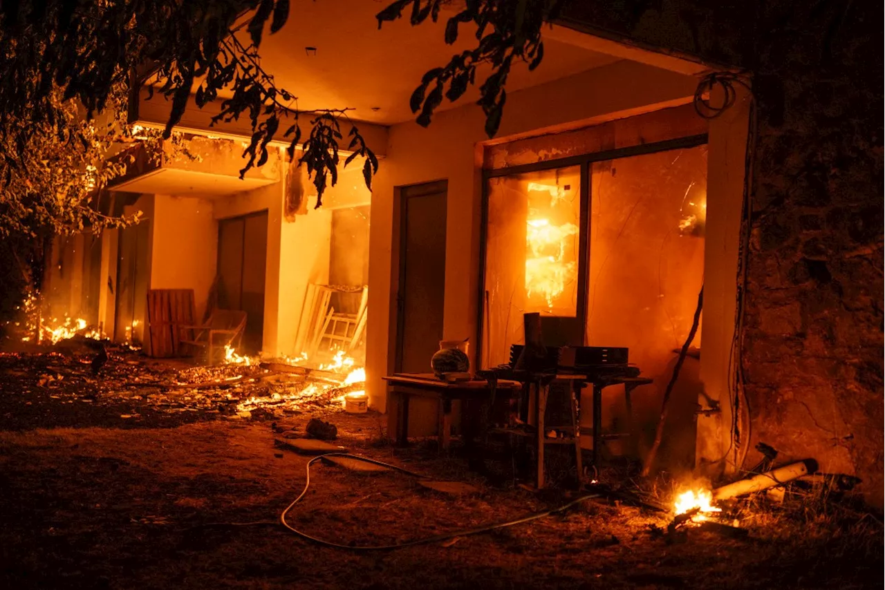 Athens suburbs burn as Greece calls on EU for help