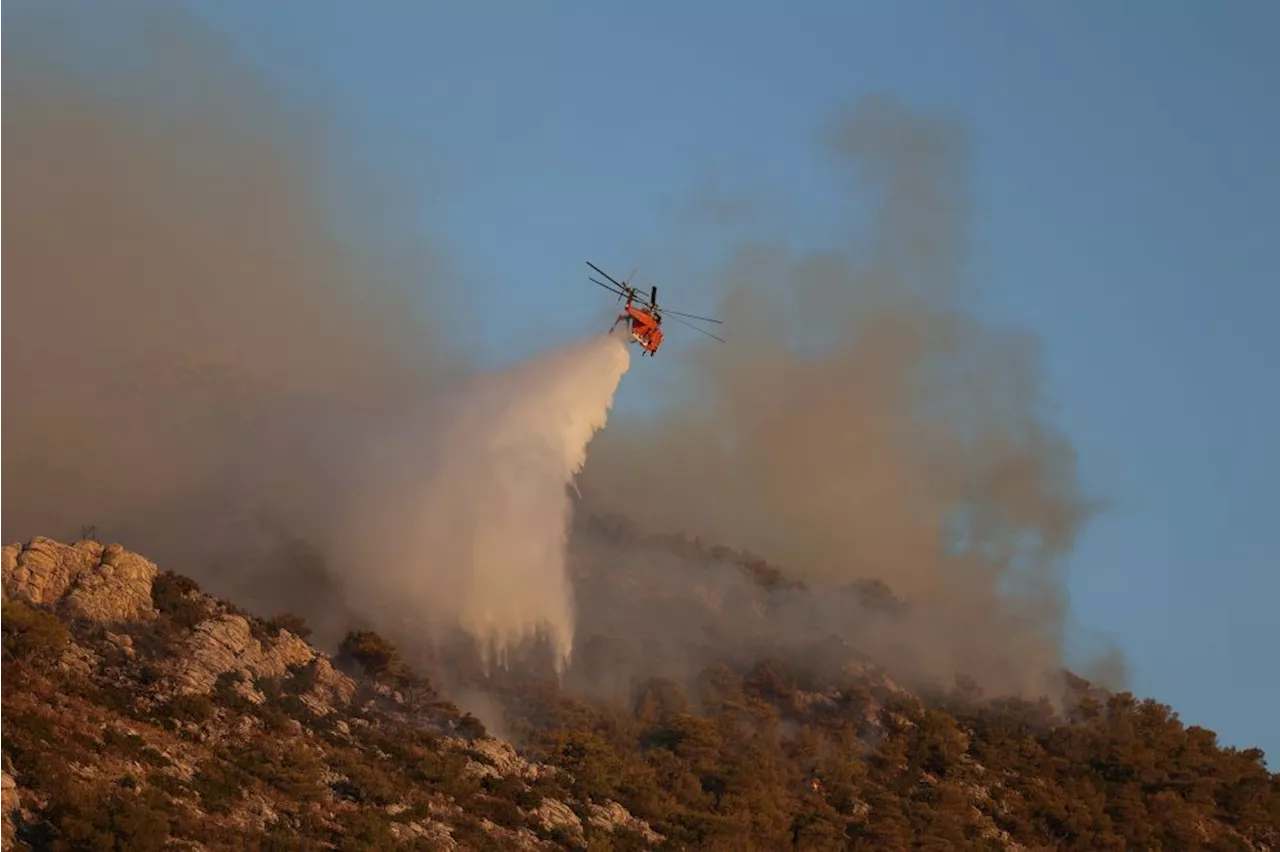 1 dead as Greek wildfire burns in Athens suburbs