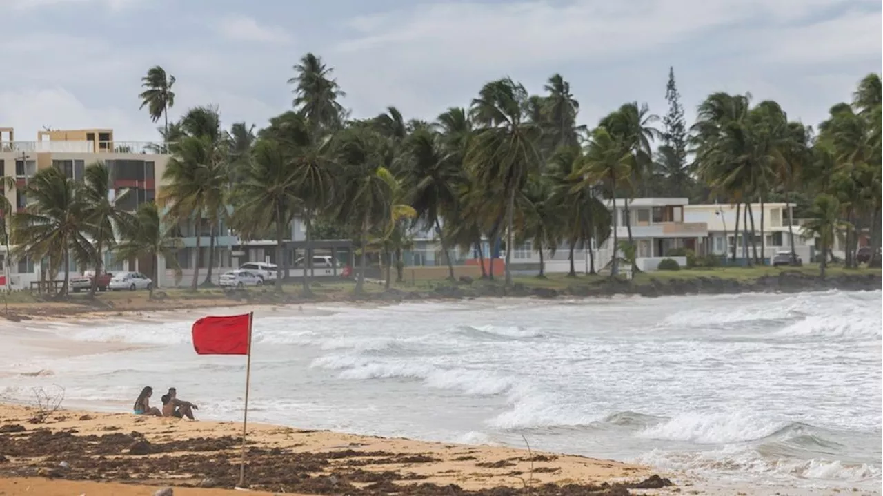 Ernesto strengthens into a hurricane, leaving half of Puerto Rico powerless