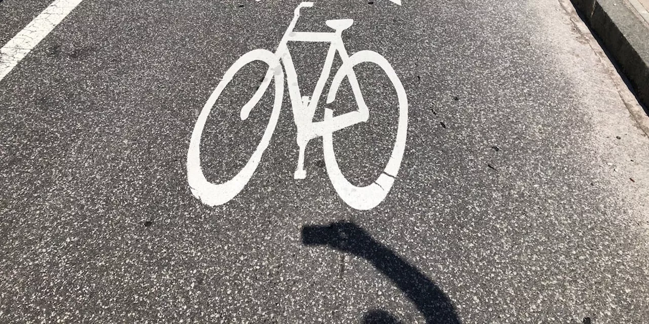 Advocates line bike lanes in Ohio City to emphasize the need for more protected lanes