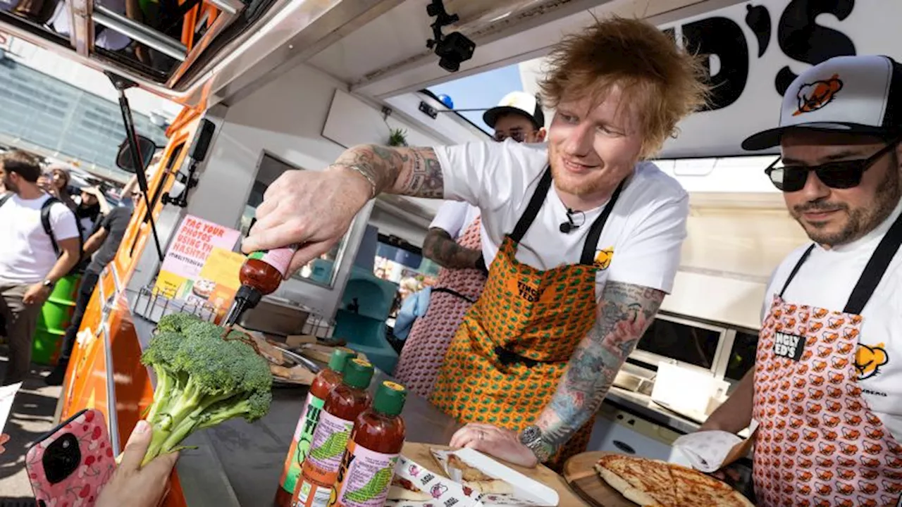 Ed Sheeran signs autographs for fans