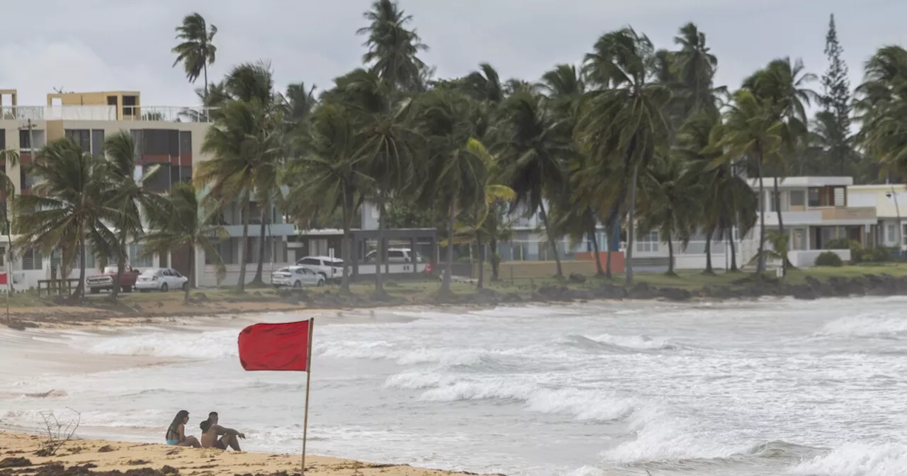 Ernesto, now a hurricane, is drenching Puerto Rico and knocking out power