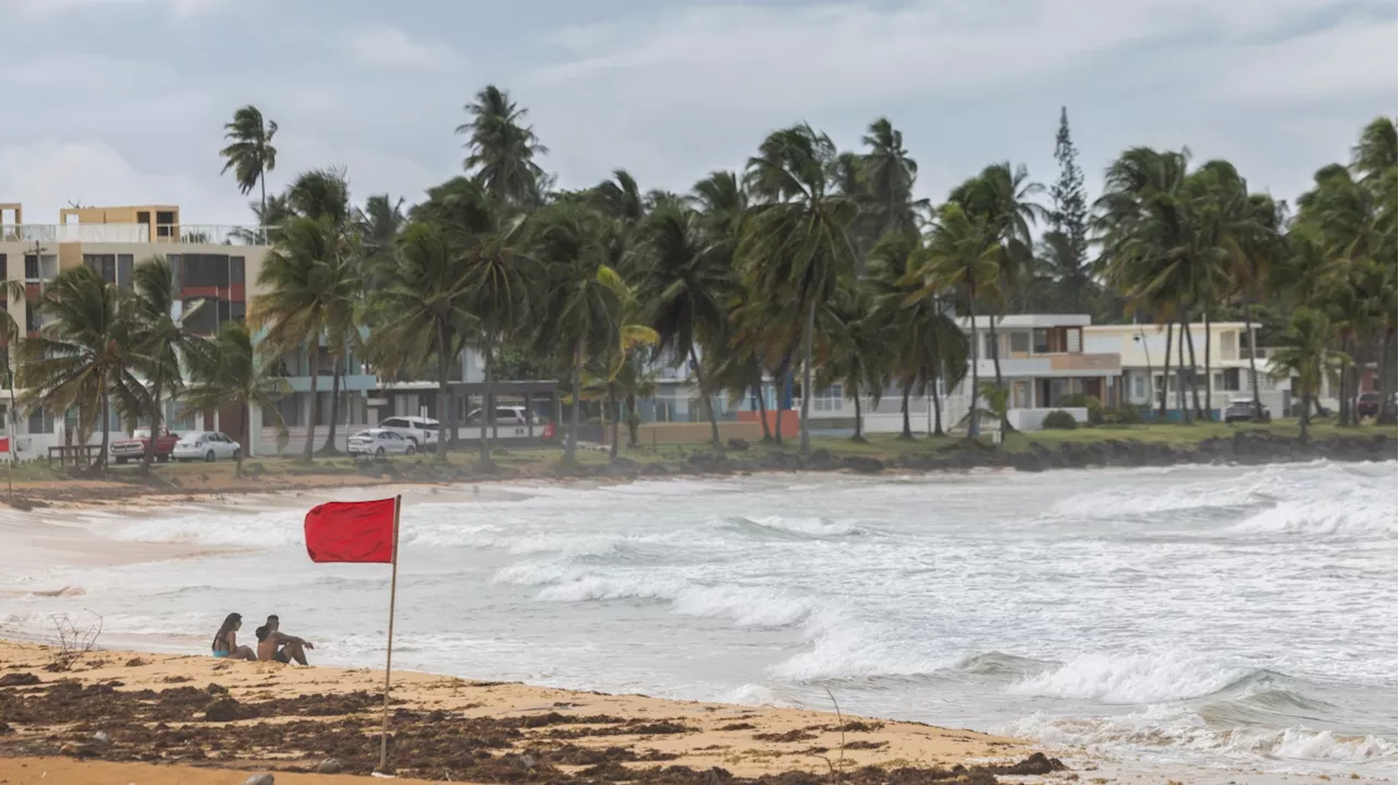 Ernesto, now a hurricane, is drenching Puerto Rico and knocking out power